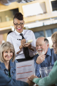 waitress-taking-order-from-table-of-senior-guests-in-restaurant